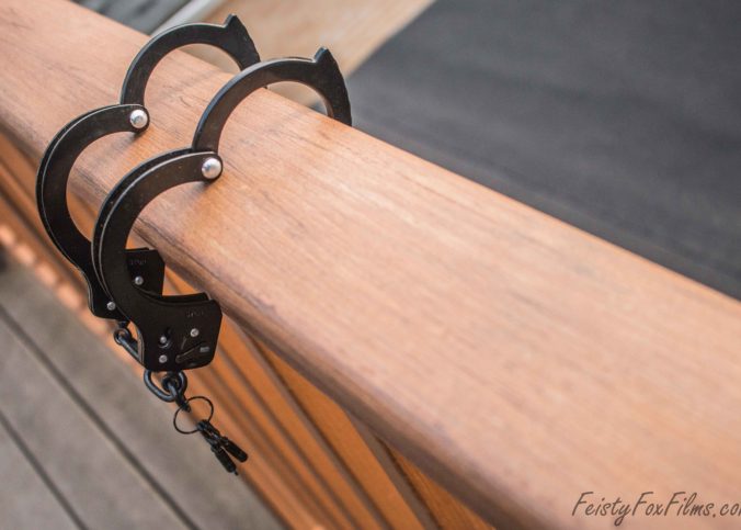 A set of handcuffs hooked over a balcony railing
